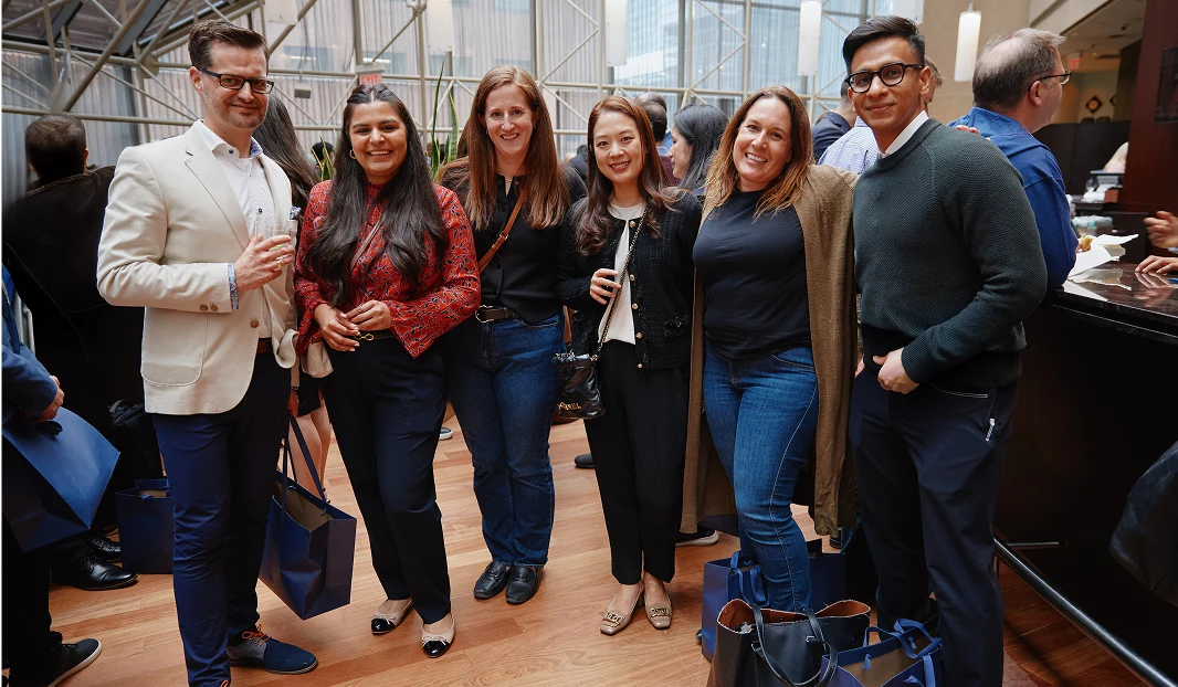 Six people standing in an atrium building