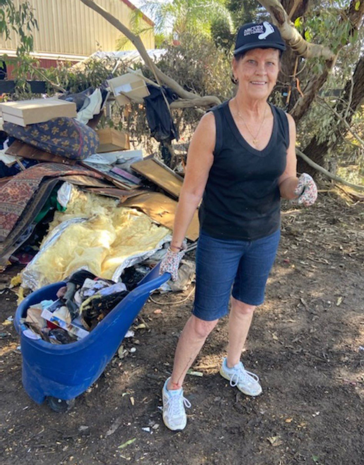 Pam Roper lends a helping hand to clean up after the recent floods.