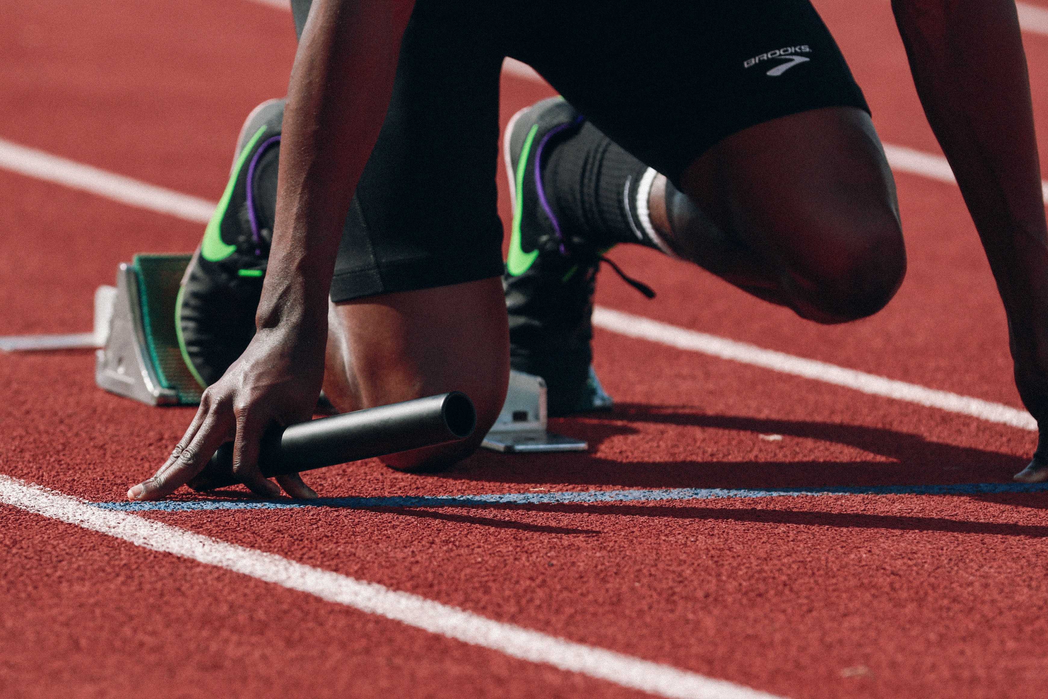Track runner crouched about to start a race