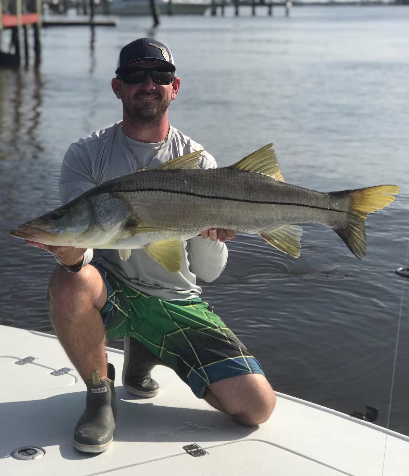 Captain Cody Baker with a trophy snook caught during Florida's mullet run.