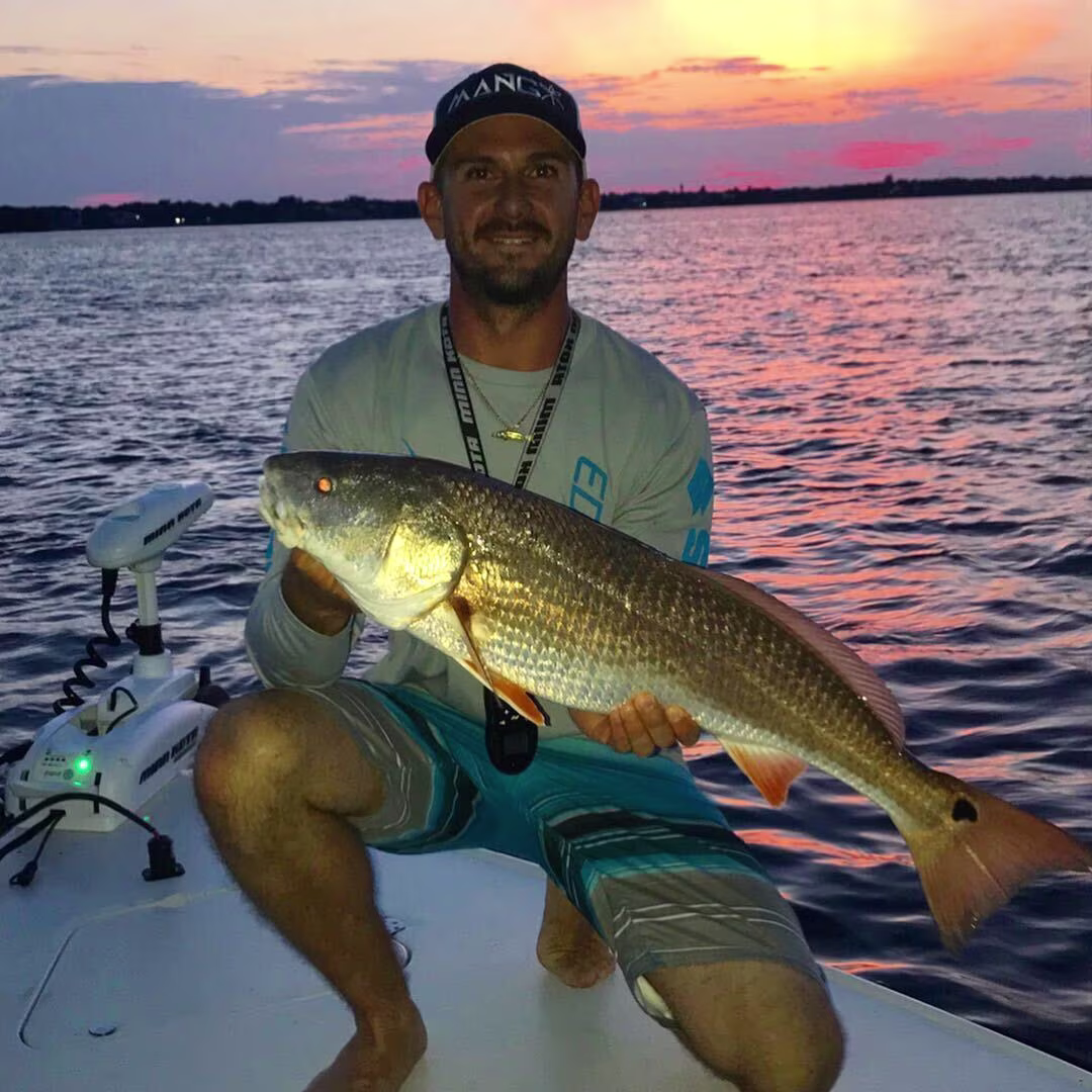 Captain Cody Baker with a redfish caught during Florida's fall mullet run.