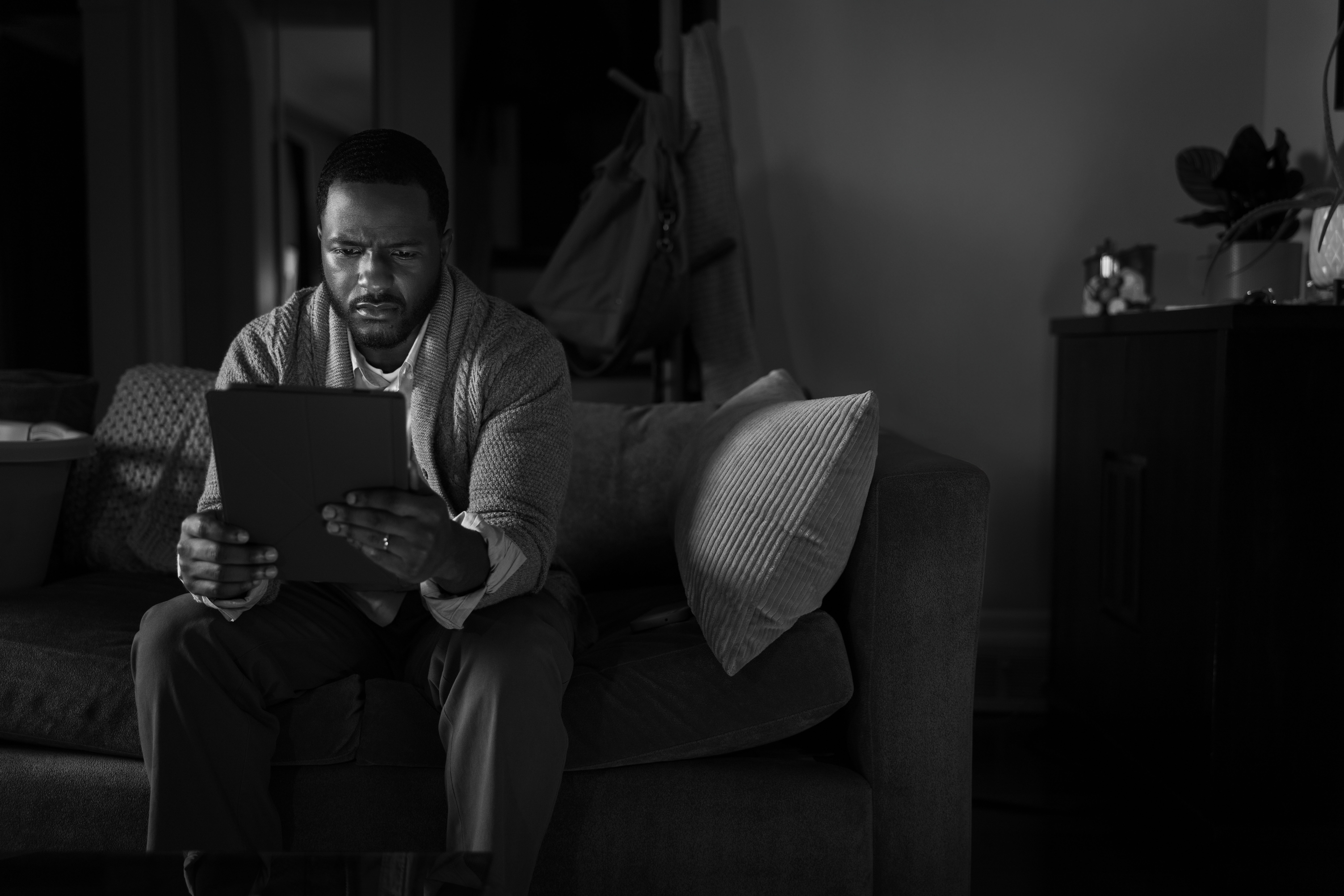 A woman sitting at a desk preparing to use a laptop.