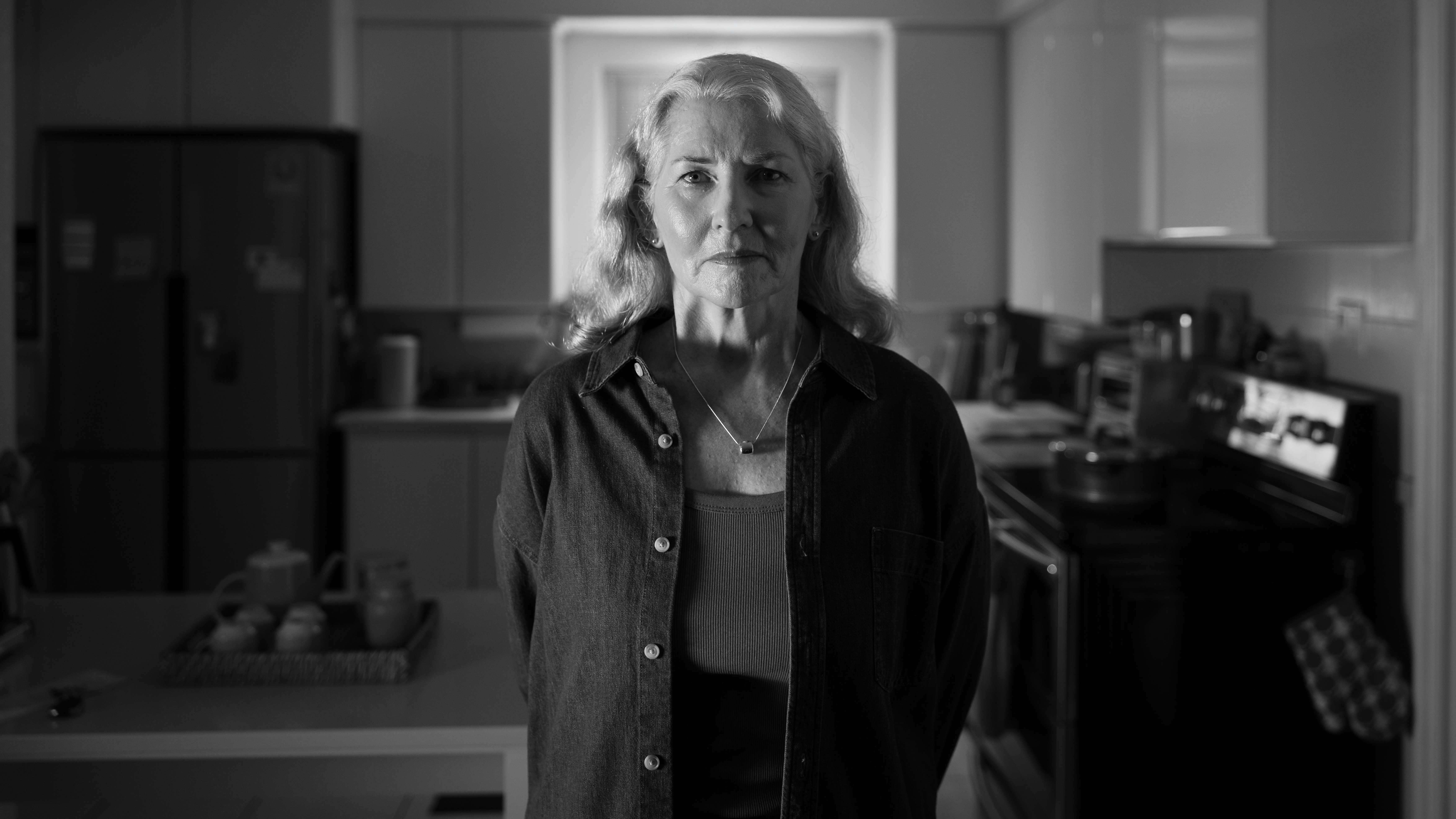 An image of a middle aged man with glasses looking directly into the camera with his arms crossed.