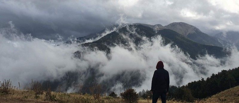 Nikos in front of Mount Kyllini covered with some low clouds