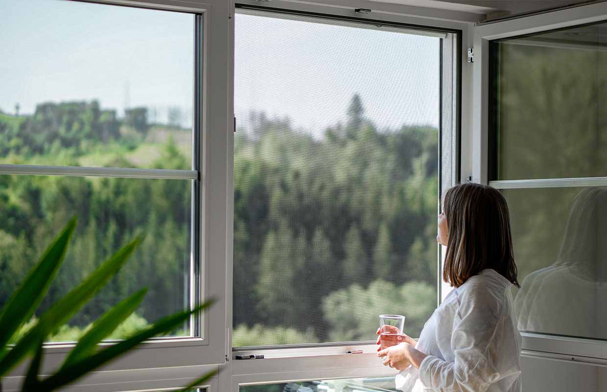 woman looks out of the window