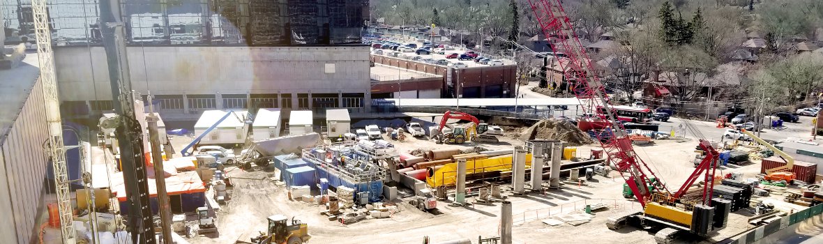 Baustelle mit Kränen und großen Fließbandmaschinen
