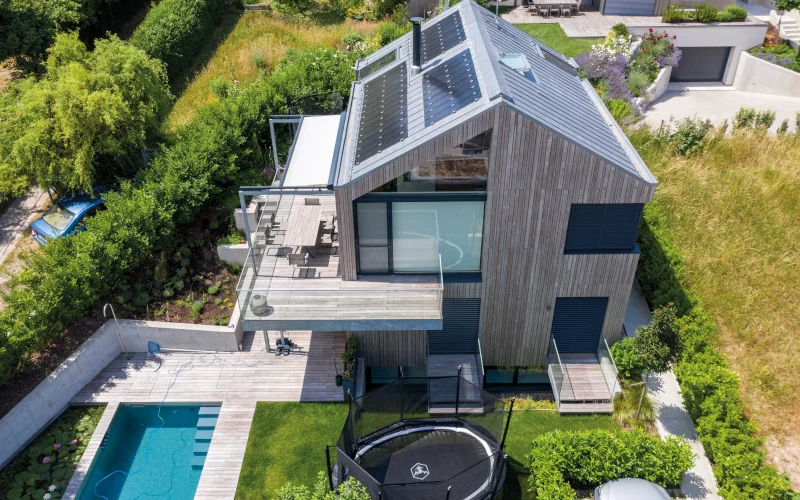 Vogelperspektive auf ein modernes Haus mit großem Garten und Pool