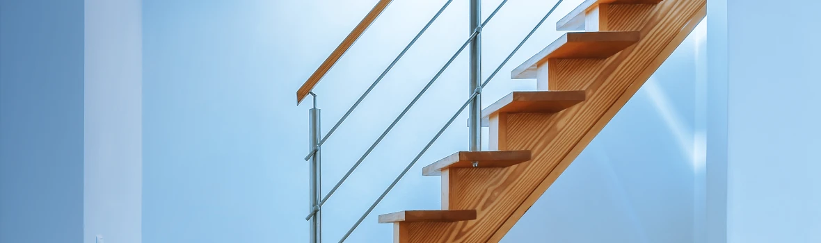Eine Holztreppe innerhalb eines Wohnzimmers führt nach oben. 