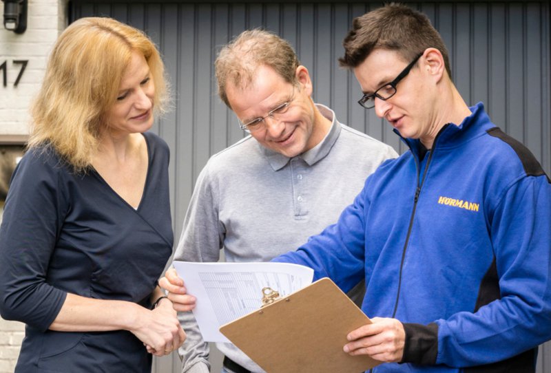 Handwerker zeigt Kunden Dokumente 