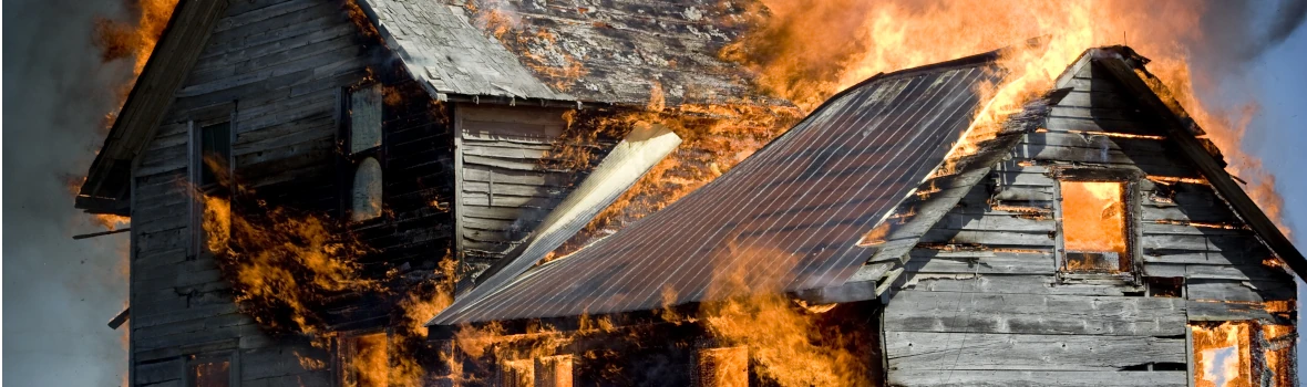 Ein Haus aus Holz steht in Flammen.
