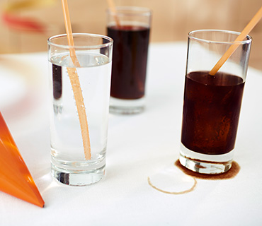 Soft drink stains on a white tablecloth