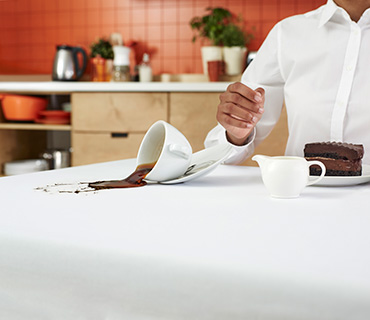 A white tablecloth stained with coffee