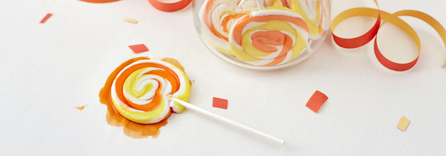 Melted swirl lollipop on white tablecloth