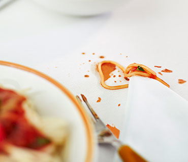 Spaghetti sauce stains on a white sheet