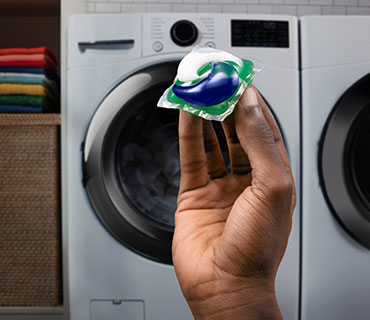A person holding a Tide PODS product
