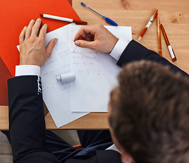 A man is correcting document with correction fluid