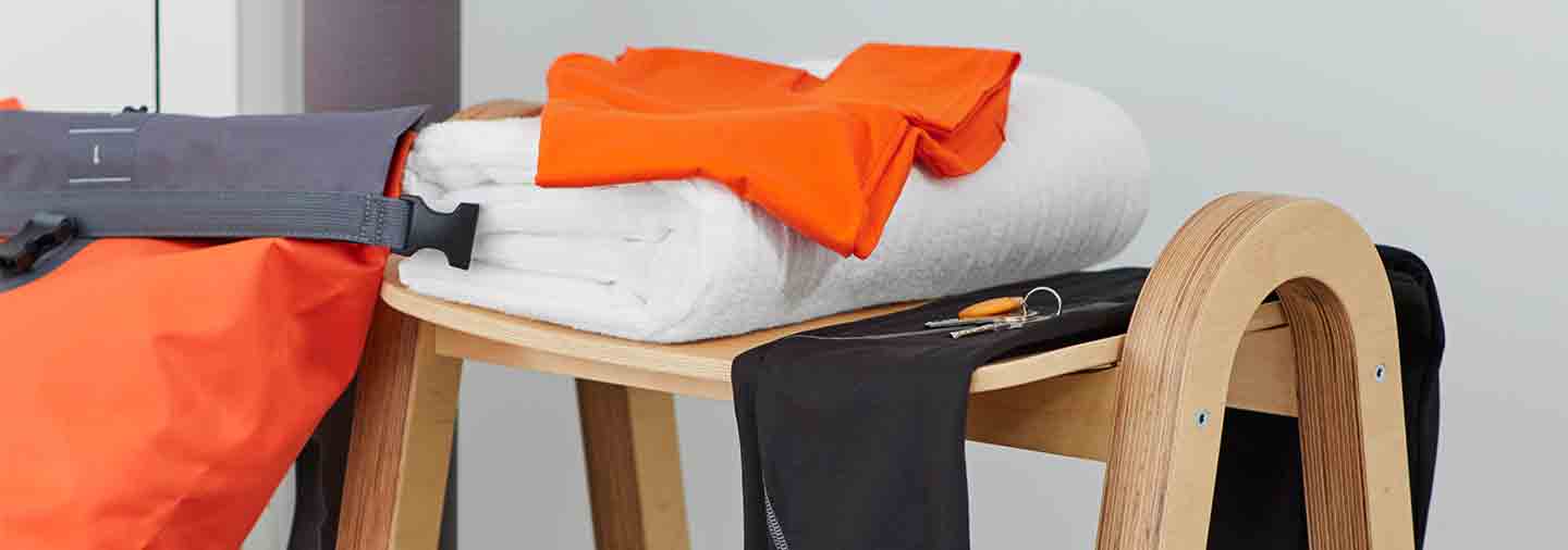 Workout clothes and a white towel on a table