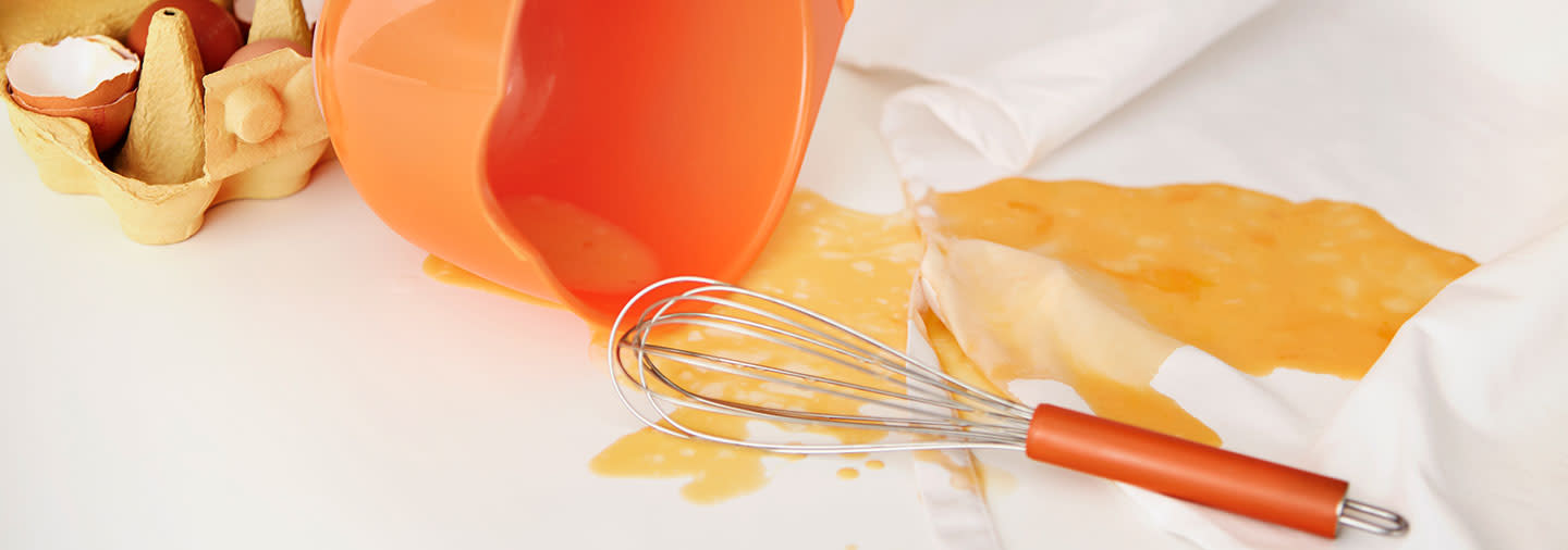 Beaten eggs spilled on white tablecloth