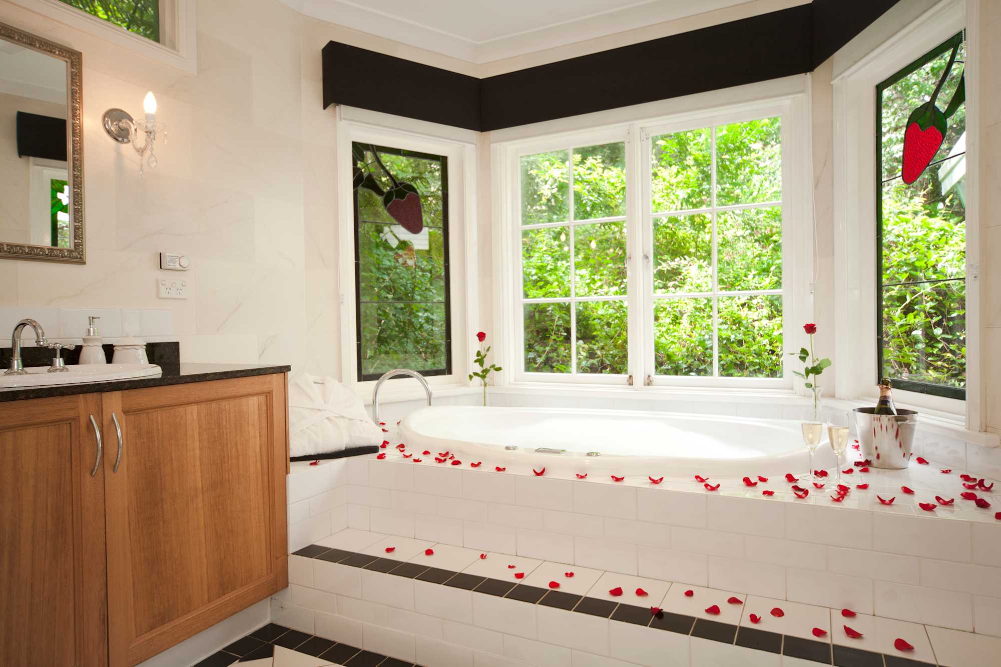 Enjoy a soak in your double spa bath overlooking the private garden at Strawberry Patch Cottage, Leura Blue Mountains