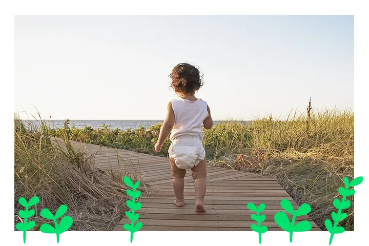 BABY IN NAPPY WALKING ON WOODEN PLATFORM