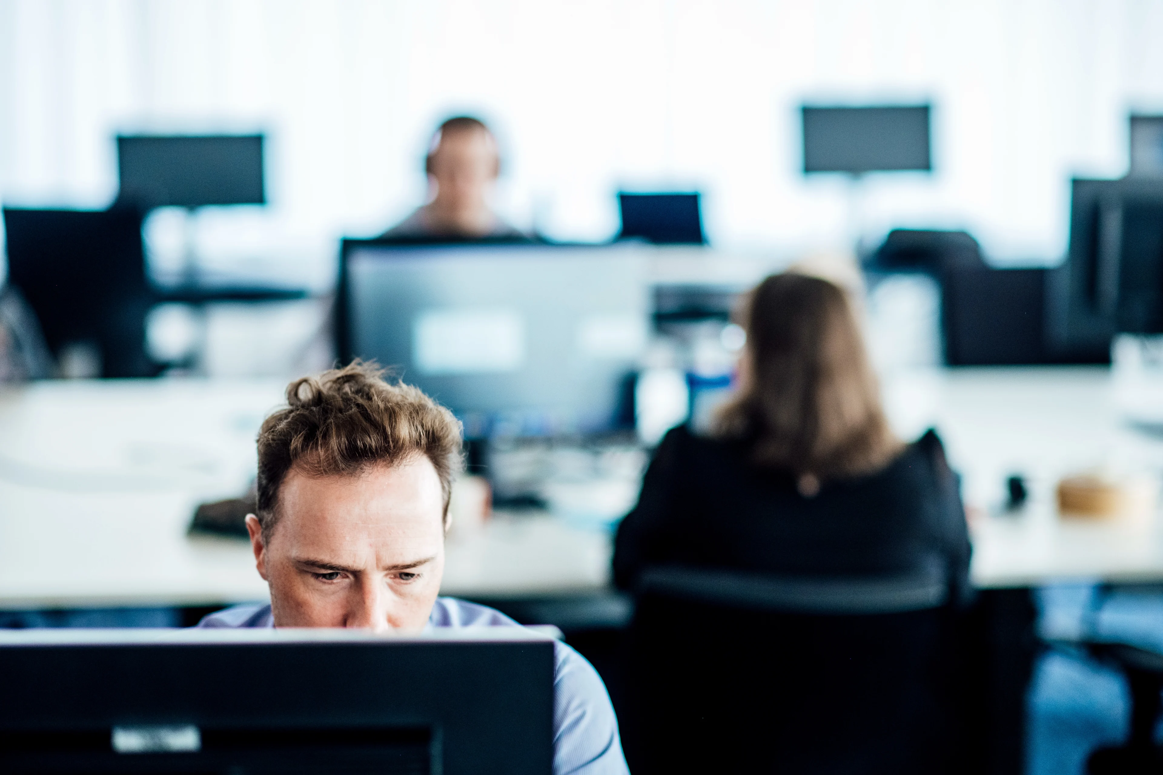 Man working at desk at DPG Media Antwerp