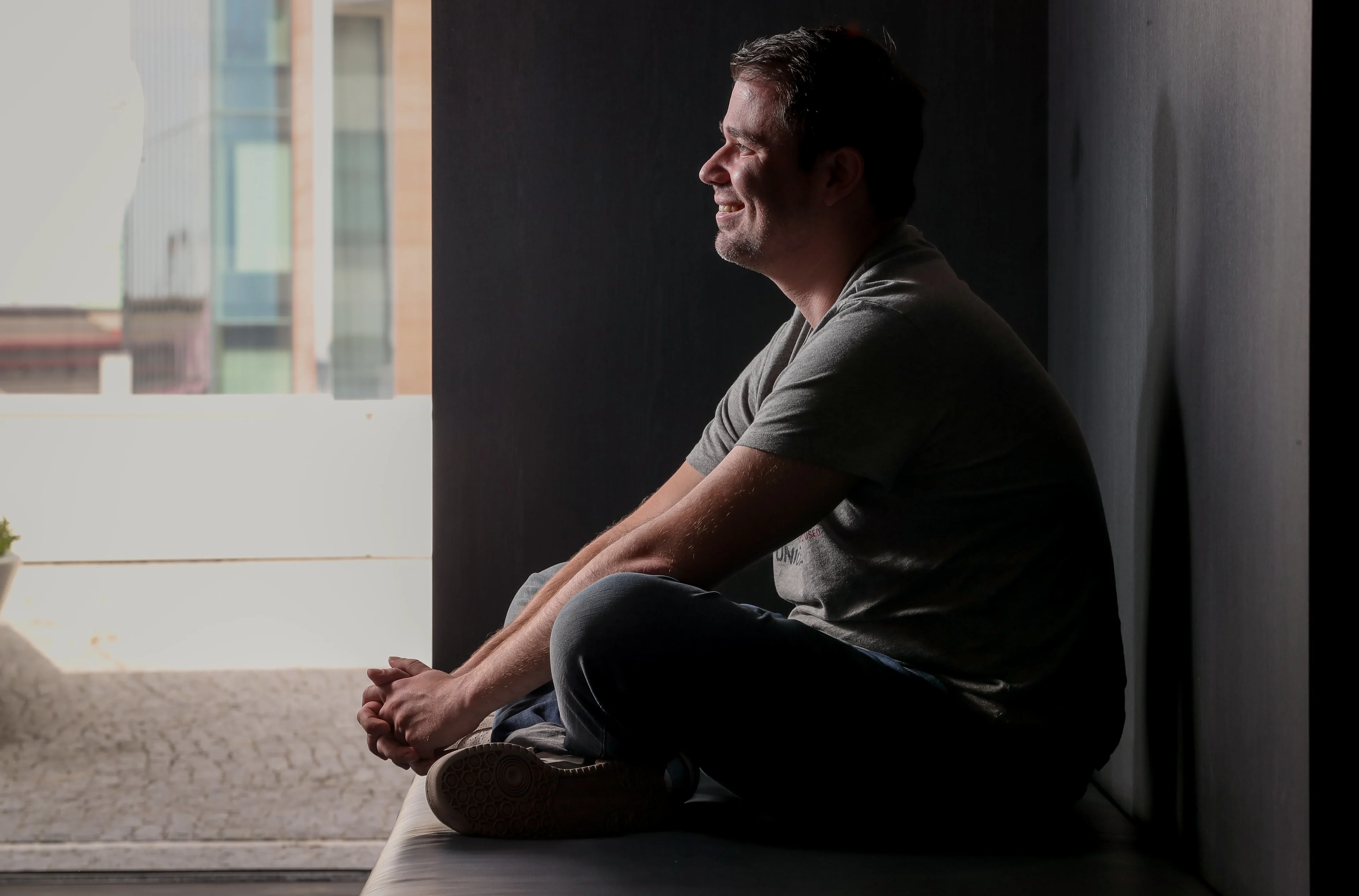 man sits with crossed legs 