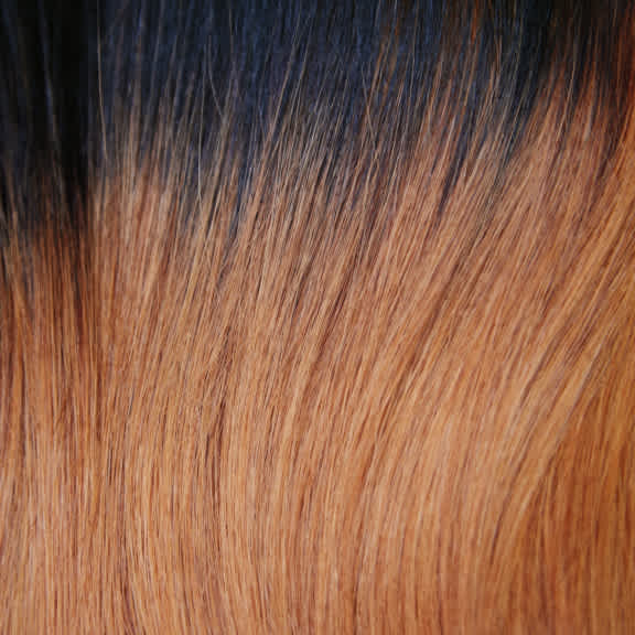 A thick fiery Two-Toned Black and Orange Center Part Bob