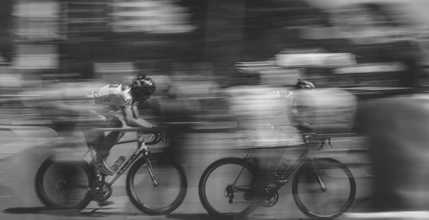 Cyclists blur black and white