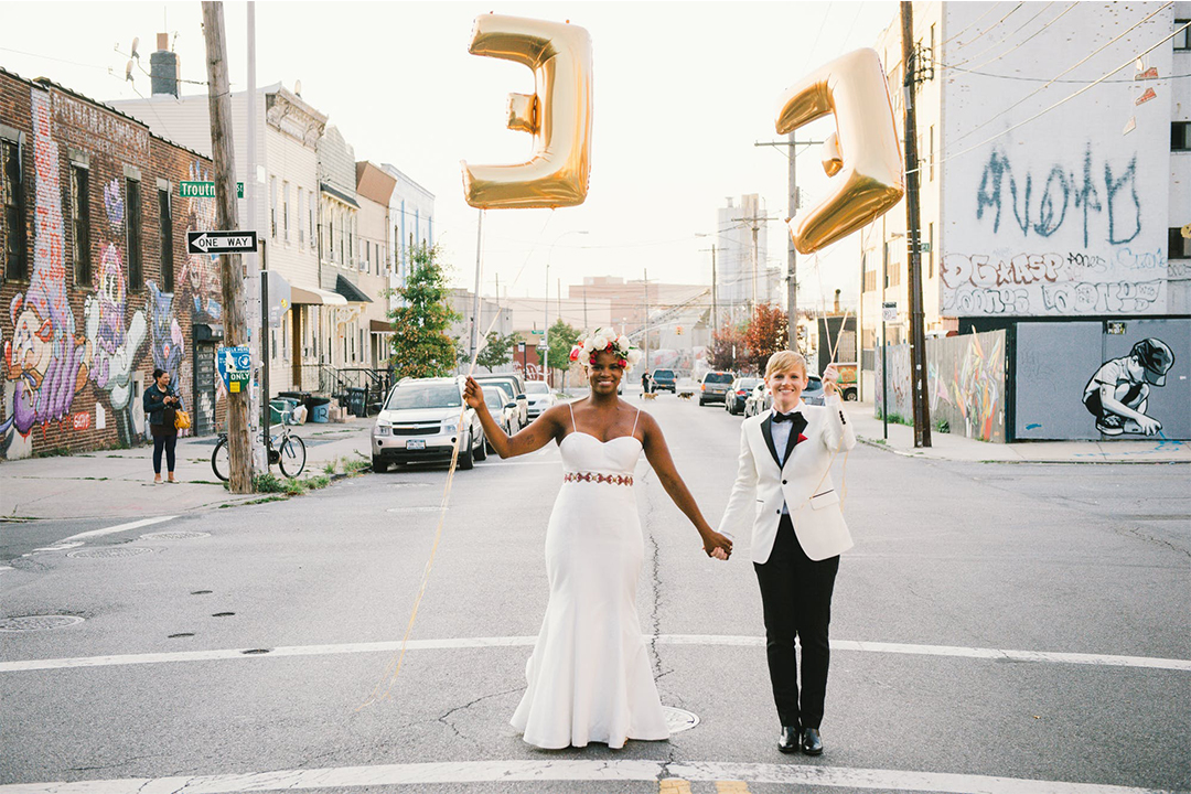 couple holding hands and balloons