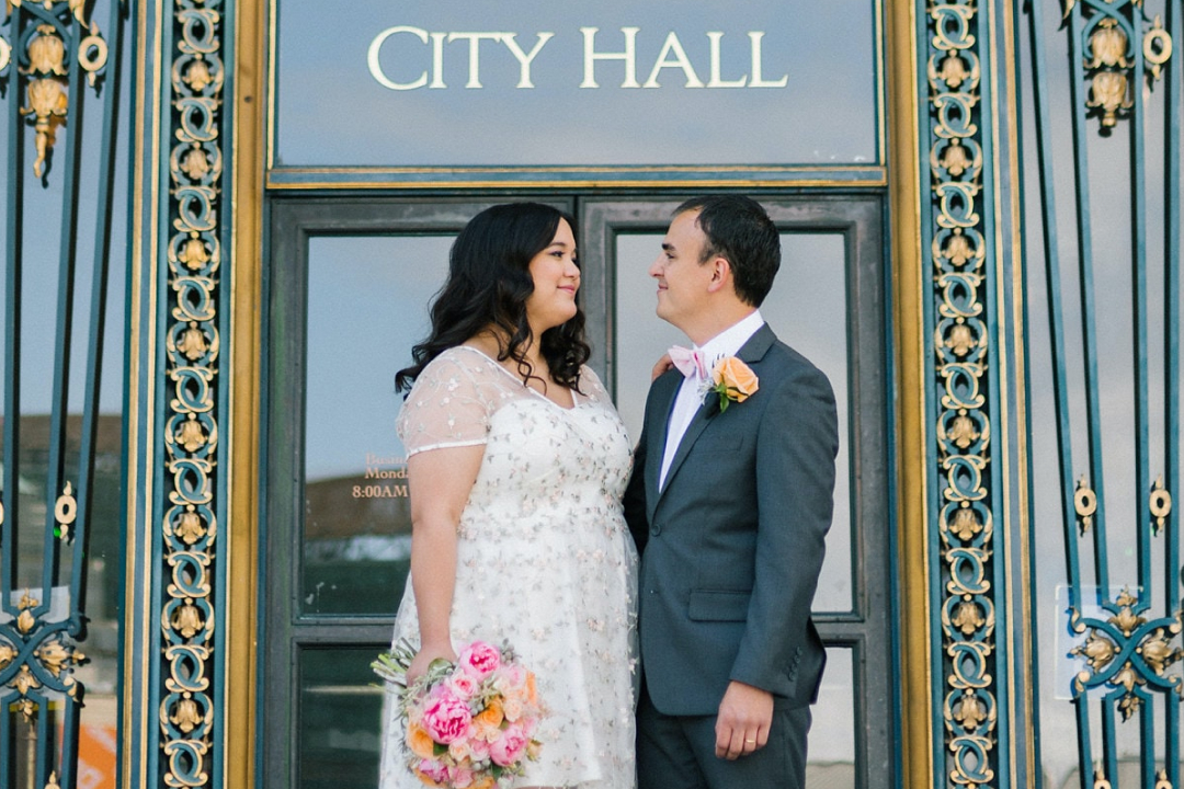Just married couple standing outside city hall