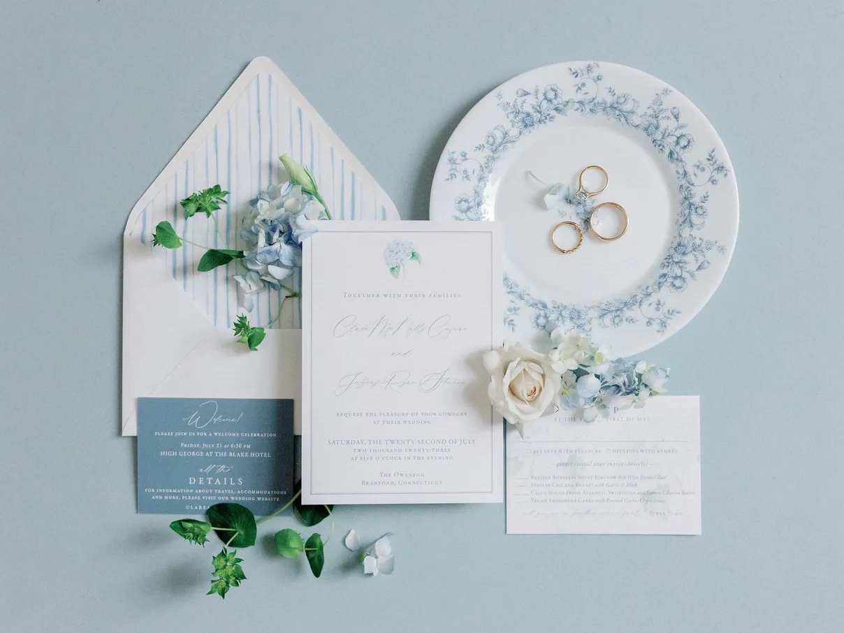 Blue and white wedding invitation flat lay blue theme
