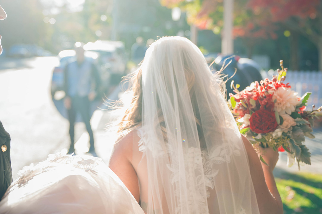 veiled bride walking to wedding