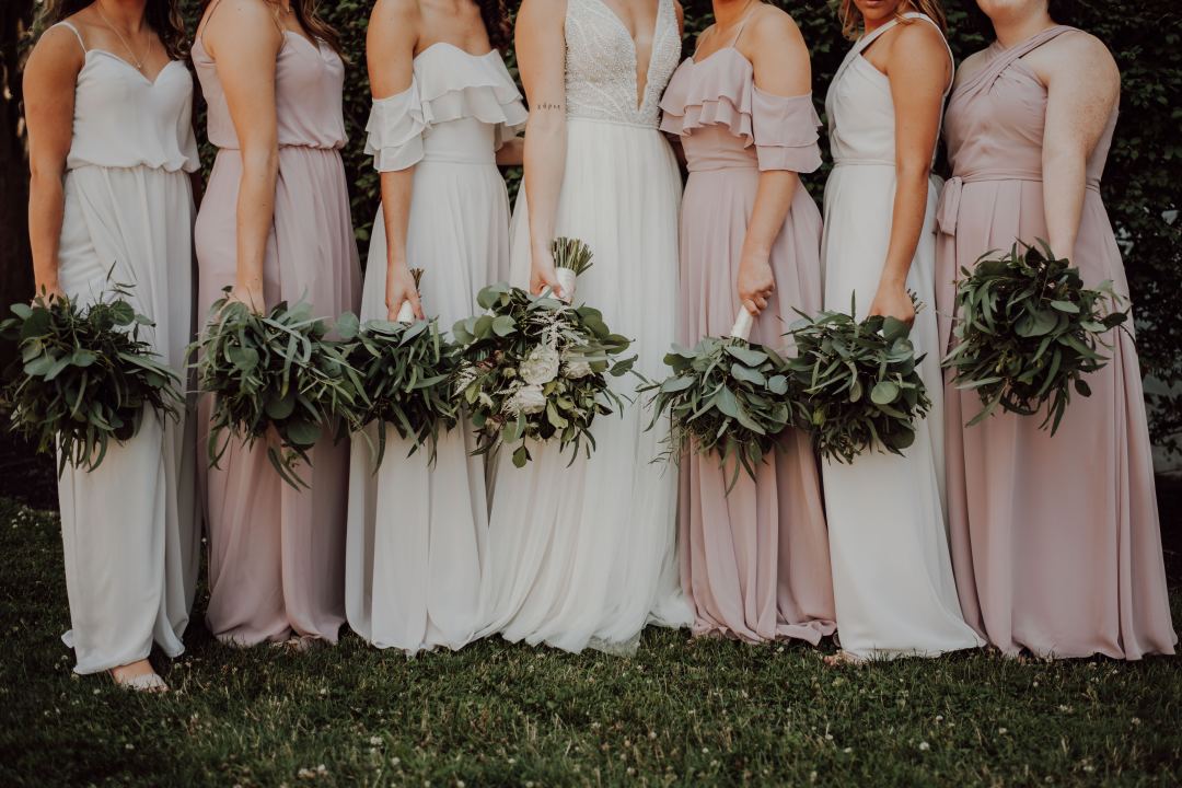 groom with bridesmaids in different dresses