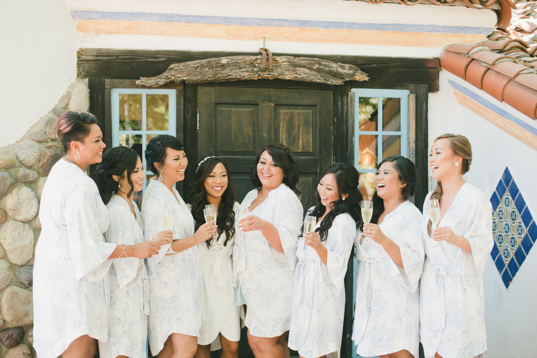 bride with bridesmaids on wedding day