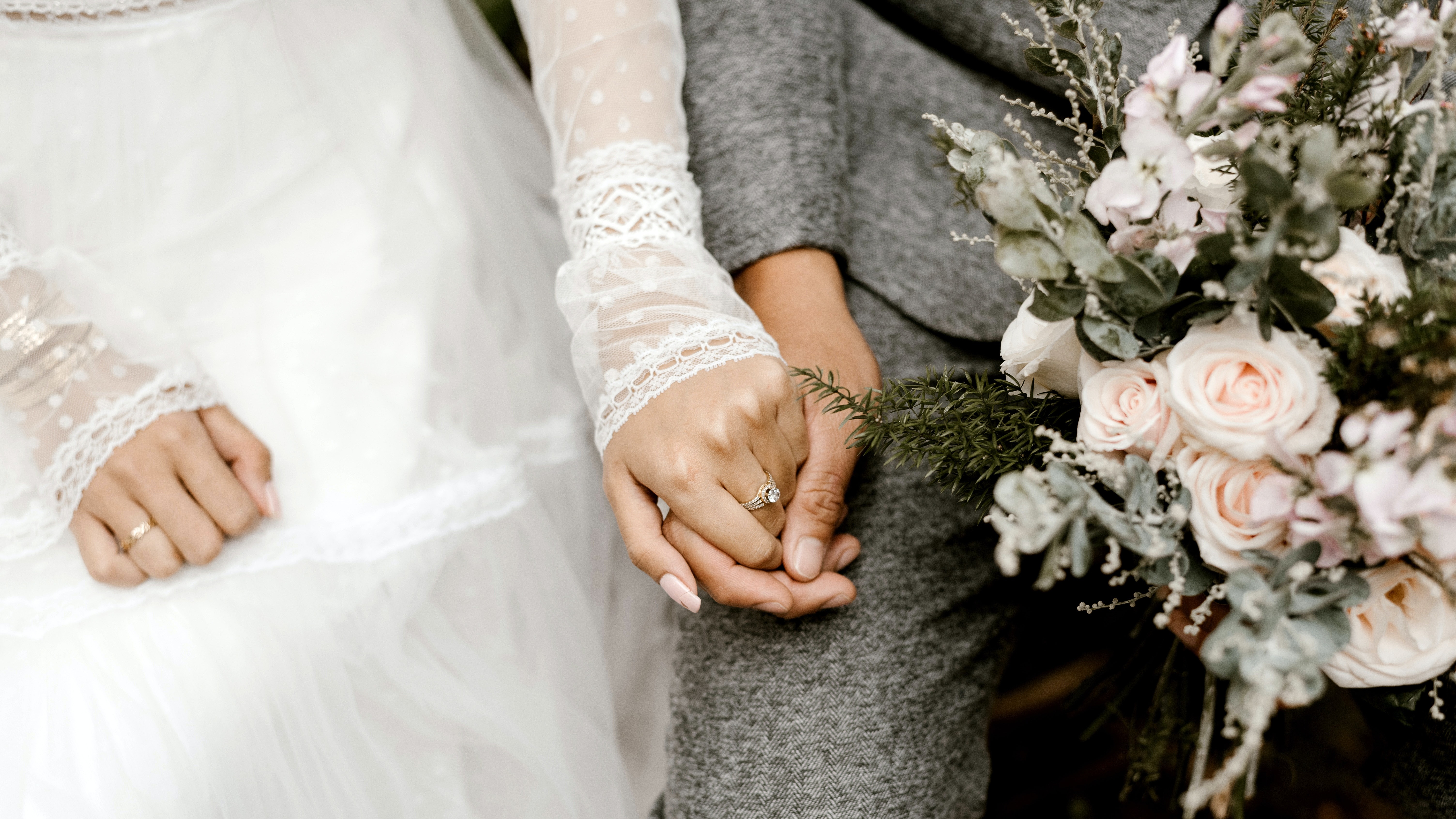 bride-groom-holding-hands-flowers