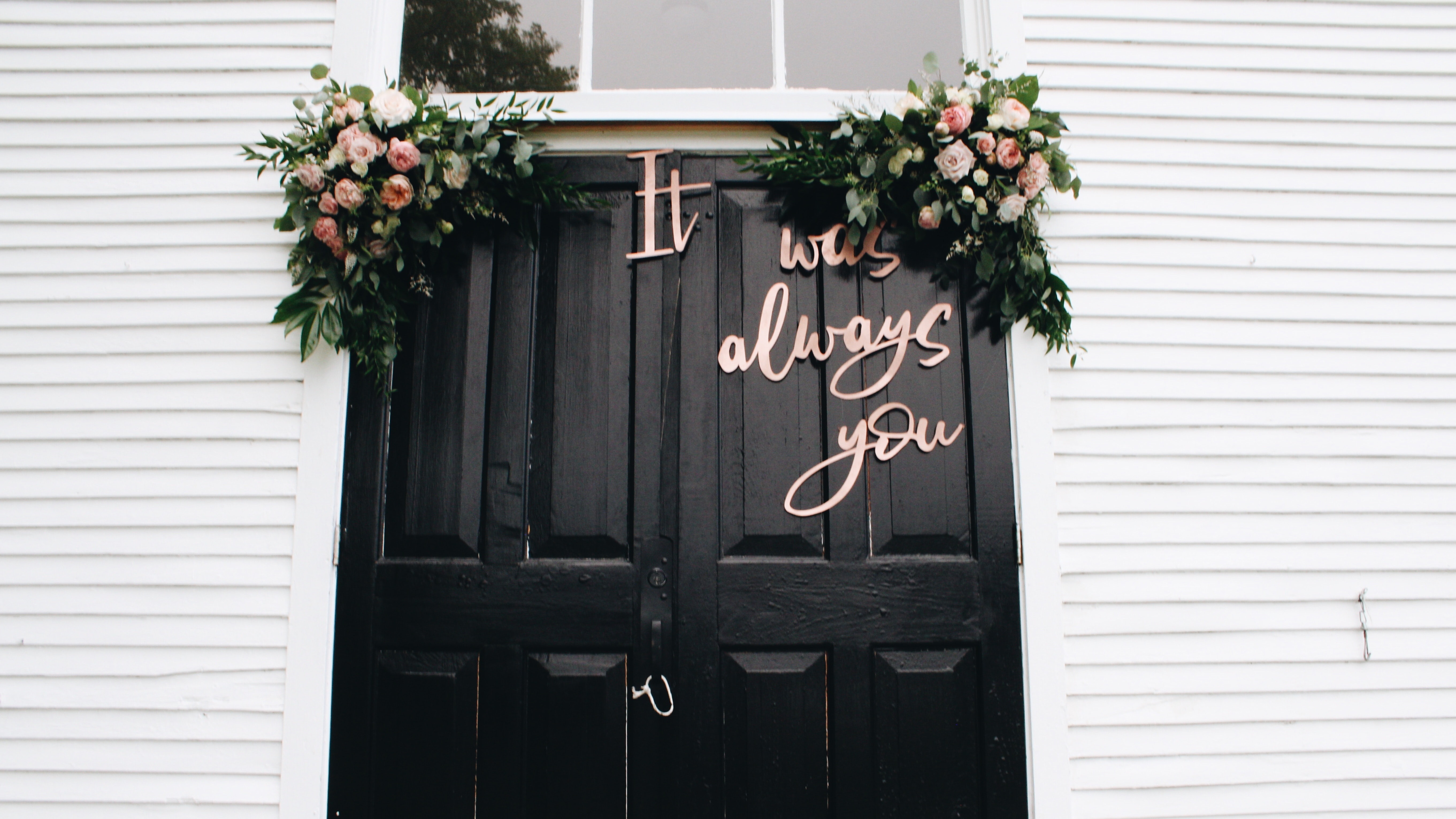 Black doors with wedding sign that reads it was always you