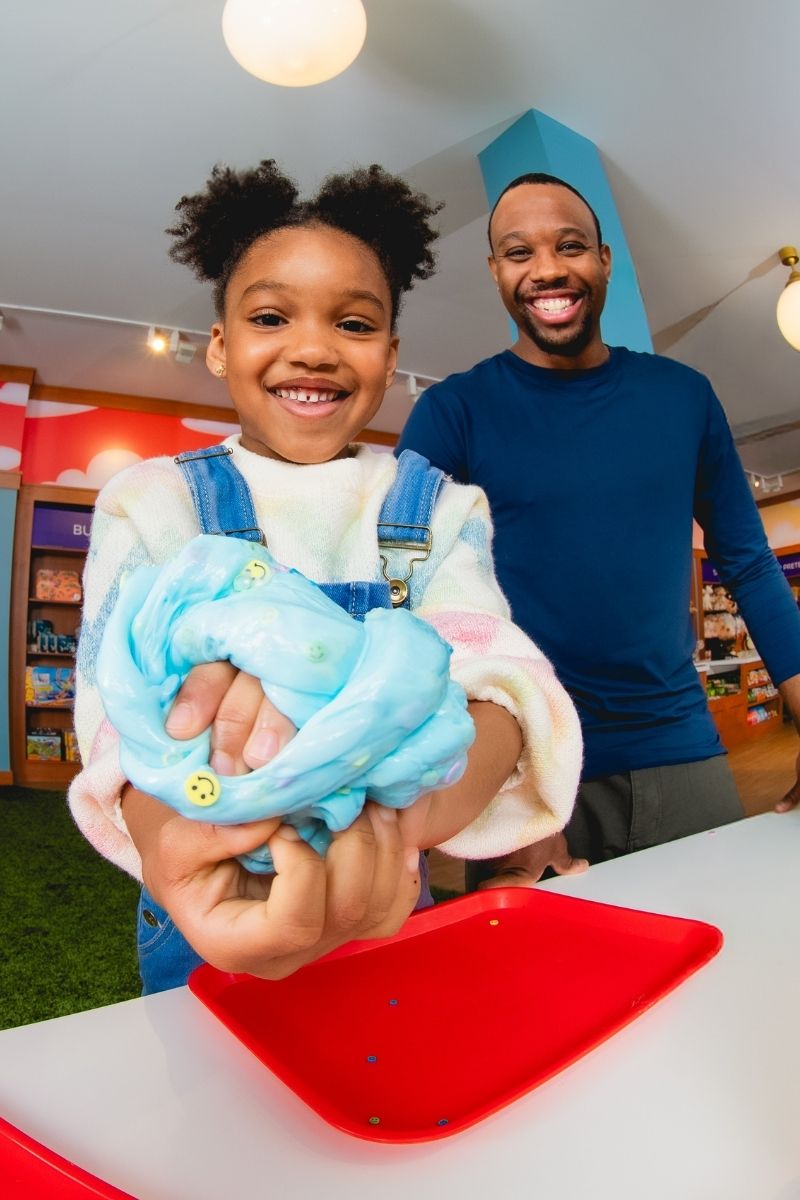Girl and Dad making slime at the Slime Bar