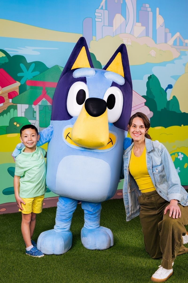 Child smiling during meet and greet with Bluey at CAMP