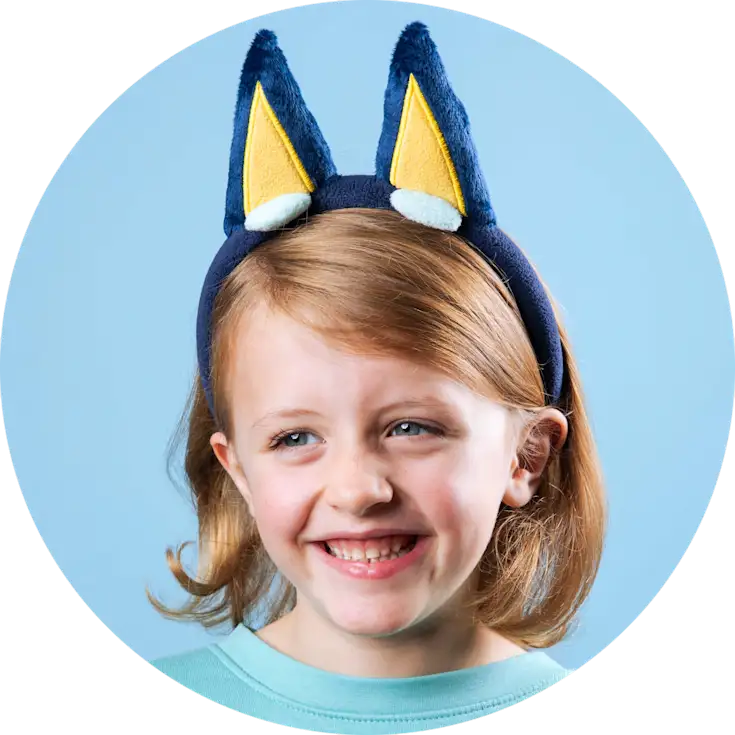 Little girl wearing Bluey ears. 
