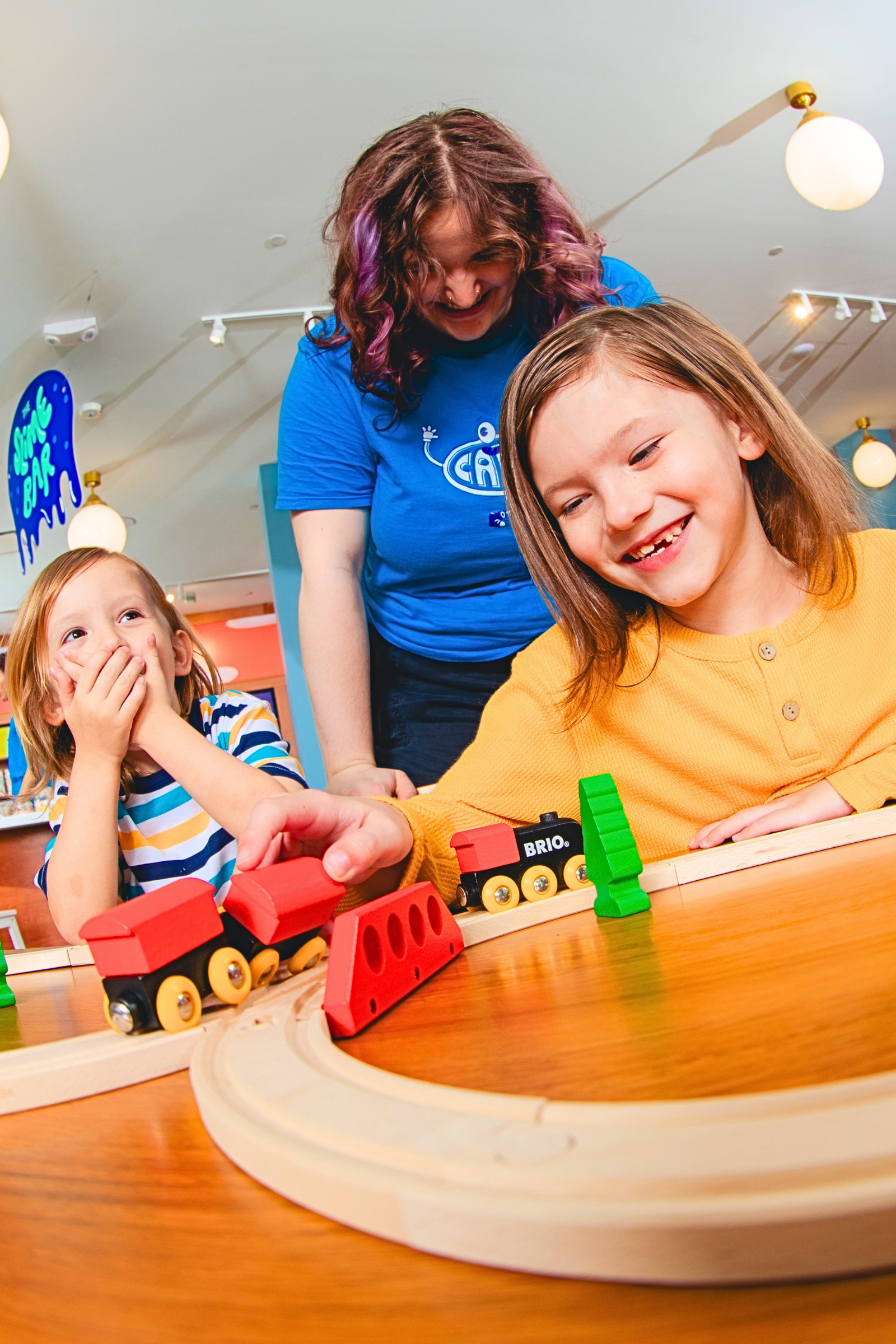 Kids inside CAMP trying out new toys