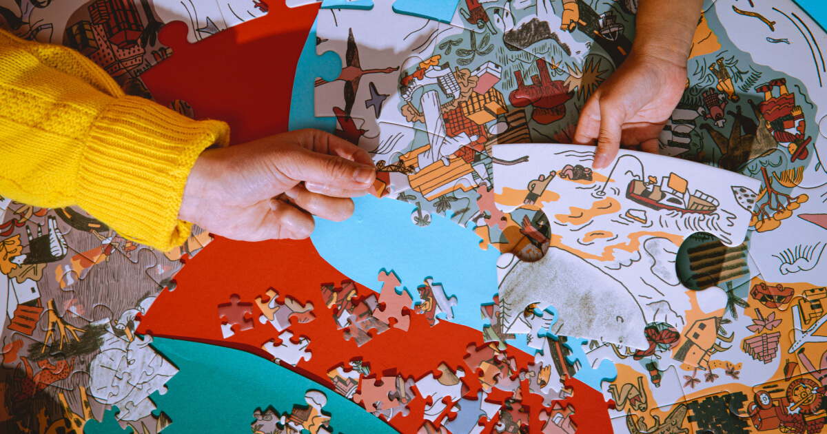 Family playing with CAMP's Paired Play puzzles