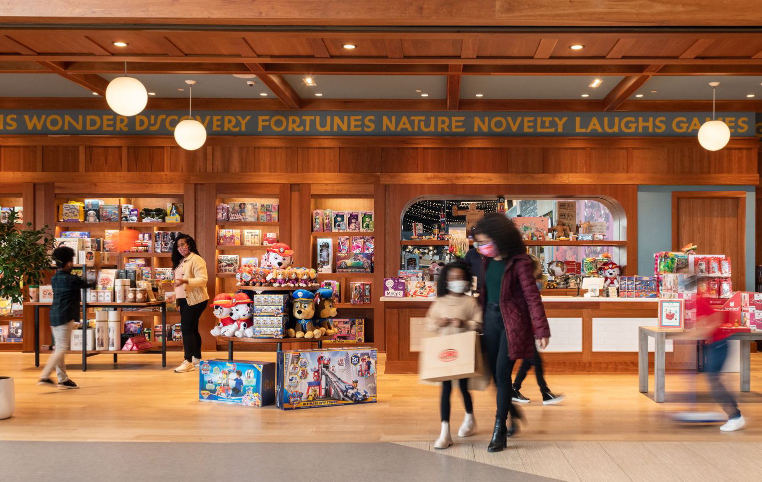 Busy CAMP store with people shopping for toys and gifts