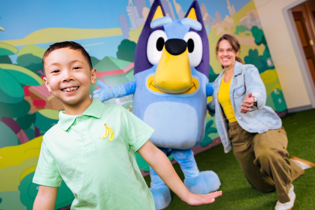 Child dancing with Bluey at Bluey's Backyard at CAMP Miami
