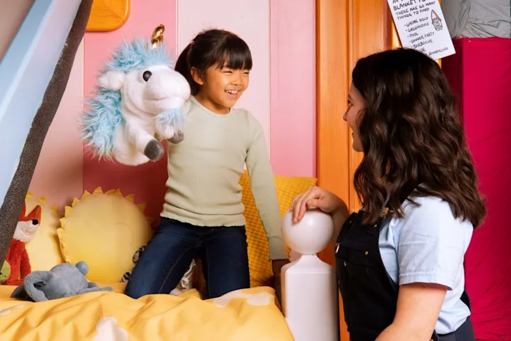 Child and CAMP Counselor playing with Unicorse in Bluey's House at CAMP