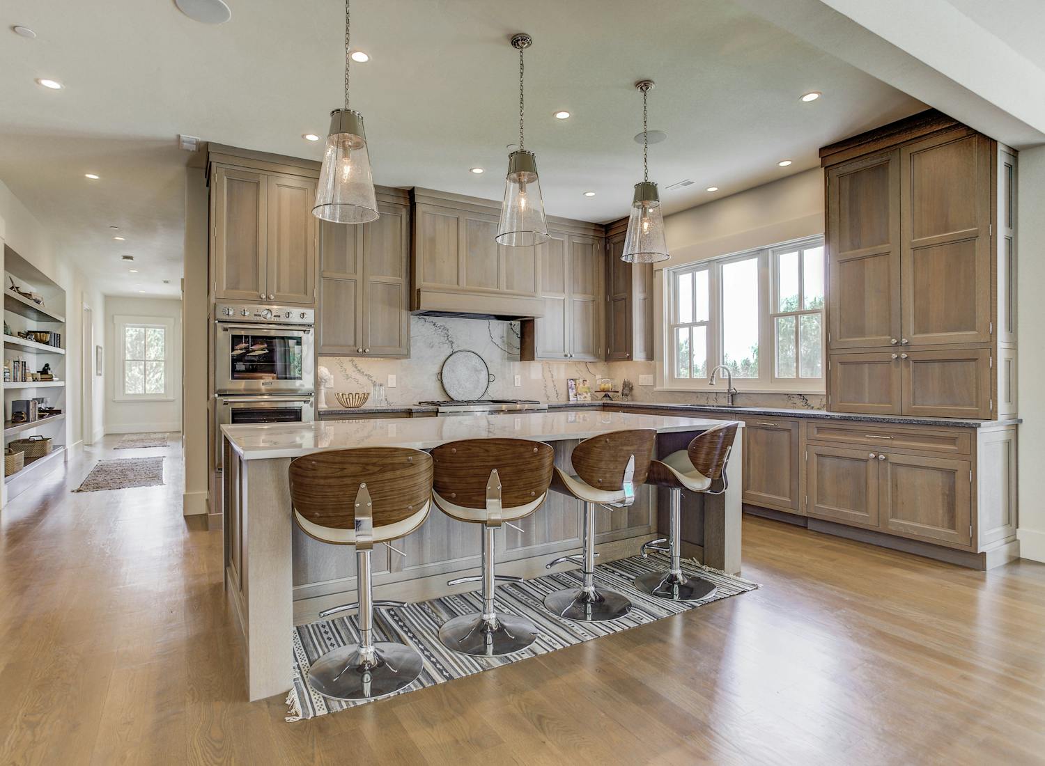 Kitchen with nice chairs around the island