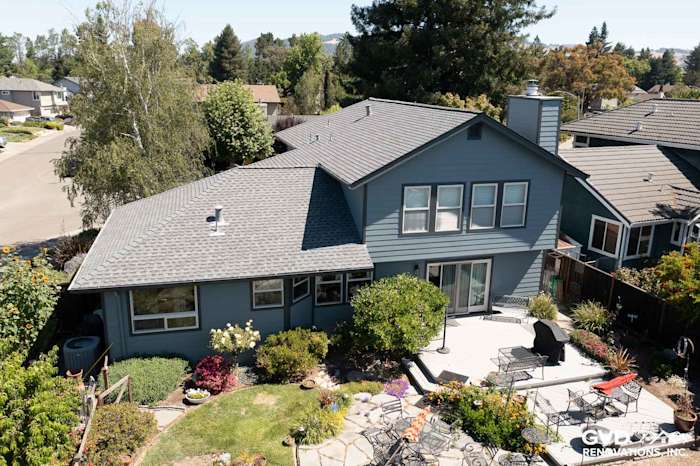 Home exterior featuring Boothbay Blue James Hardie siding, Milgard windows, and landscaped patio in Rohnert Park