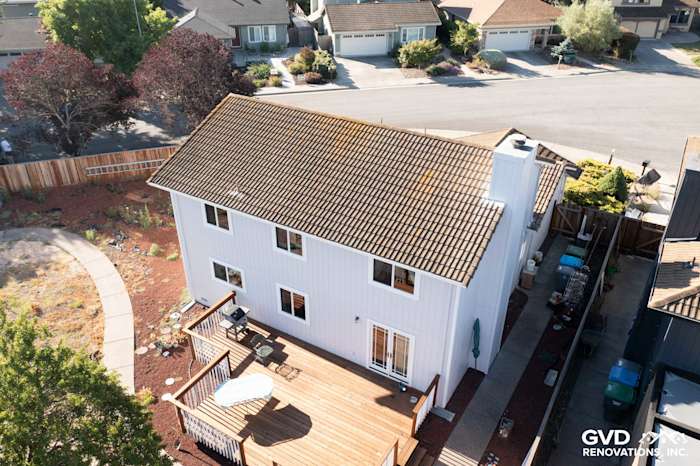 Updated home exterior featuring white James Hardie siding, new windows, and a deck in Petaluma, CA