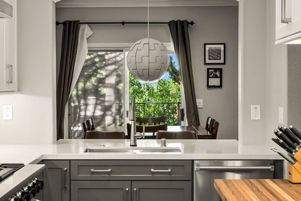 Modern kitchen remodel in Folsom with gray cabinetry, marble backsplash, and star-patterned tile floor