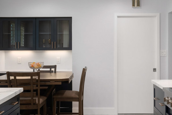 Modern kitchen remodel featuring blue and white cabinetry, stainless steel appliances, and quartz countertops in Sacramento