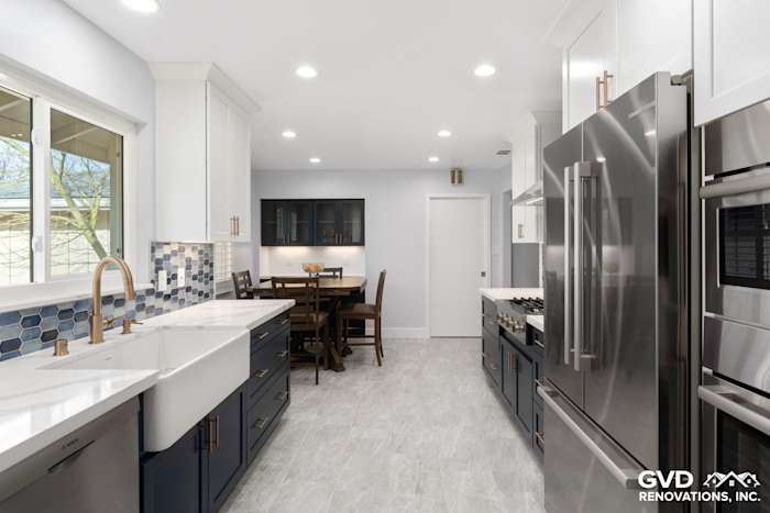 Modern kitchen remodel featuring blue and white cabinetry, stainless steel appliances, and quartz countertops in Sacramento